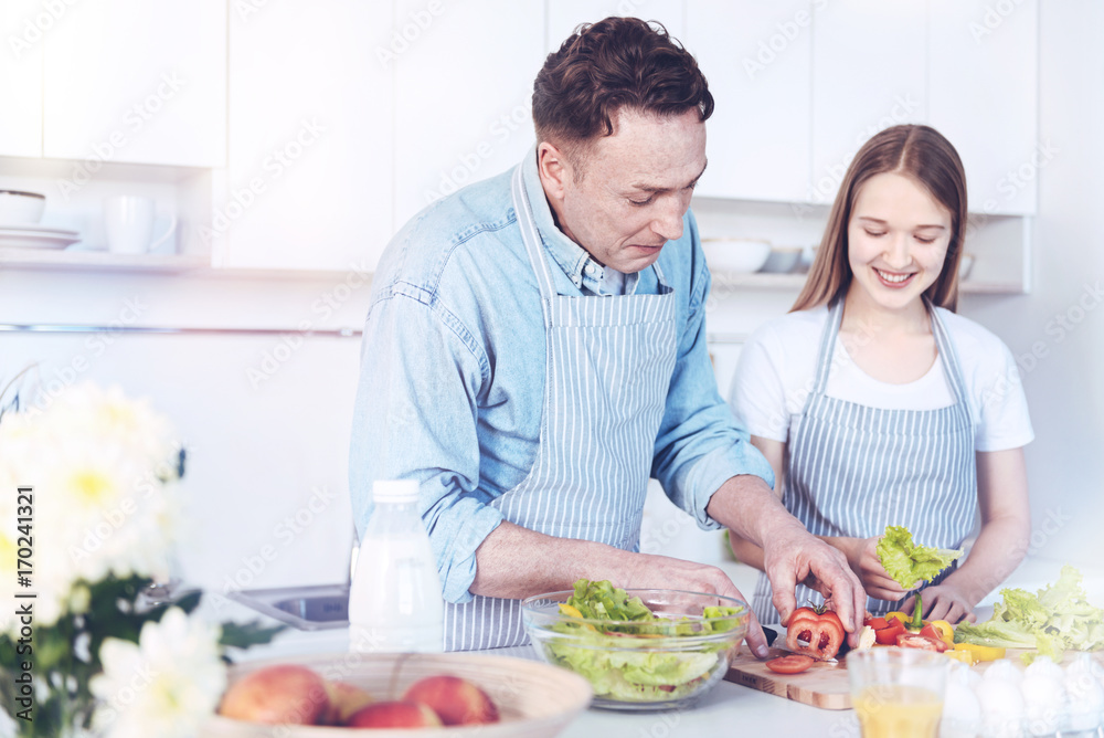 Daughter and dad enjoying cooking together