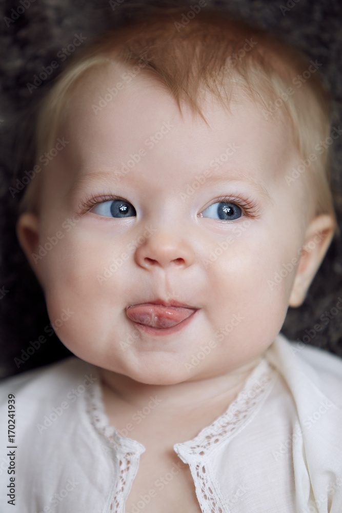 Beautiful cute adorable baby smiling showing tongue Beautiful cute adorable baby smiling showing tongue