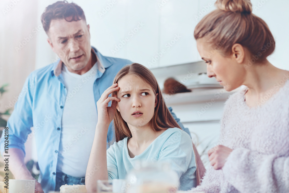 Scared parents discussing misbehavior of their daughter Scared parents discussing misbehavior of their daughter