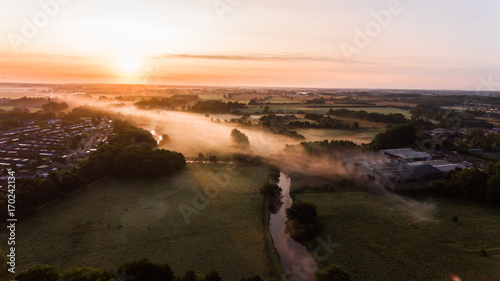 Sunrise over fields in denmark photo