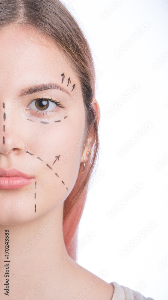 Beautiful young woman at white background, plastic surgery concept, portrait, correction lines on face
