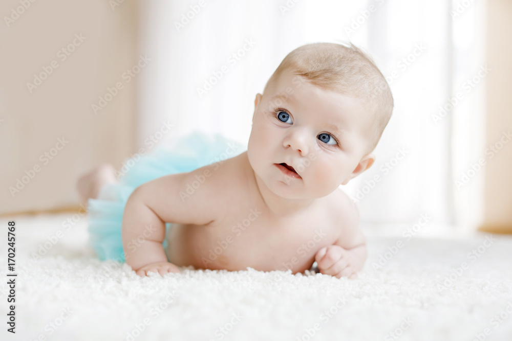 Adorable baby girl on white background wearing turquoise tutu skirt. Adorable baby girl on white background wearing turquoise tutu skirt.