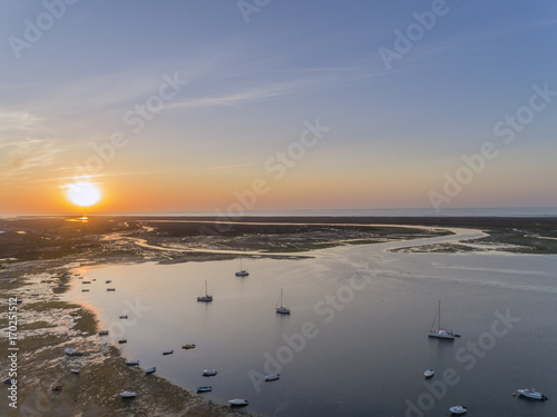 Sunrise aerial seascape, in Ria Formosa wetlands natural park, shot at 60m altitude over Cavacos beach. Algarve. photo