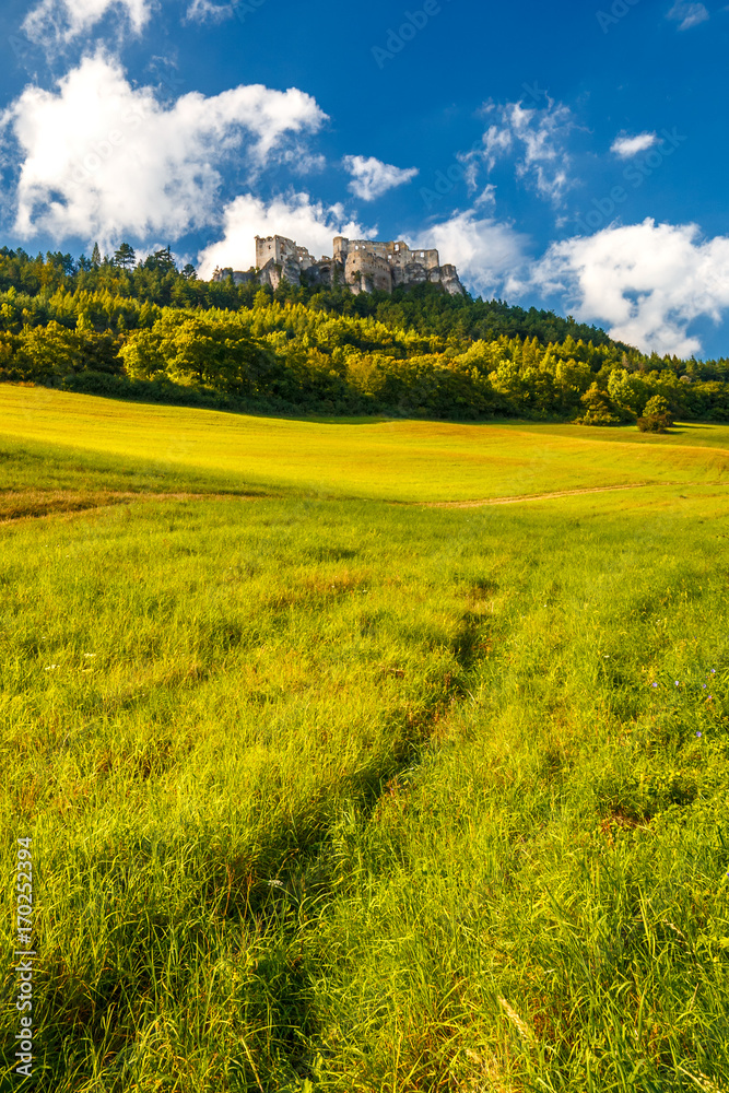 The ruins of a medieval castle Lietava on a rocky blade over a wooded landscape and grassy meadows, nearby Zilina town, Slovakia, Europe. The ruins of a medieval castle Lietava on a rocky blade over a wooded landscape and grassy meadows, nearby Zilina town, Slovakia, Europe.
