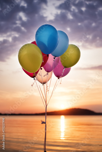 Colorful Balloons On The Bridge At The Sea And A Beautiful Sunset. Birthday Party Balloons