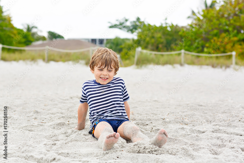 Little kid boy having fun on tropical beach Little kid boy having fun on tropical beach