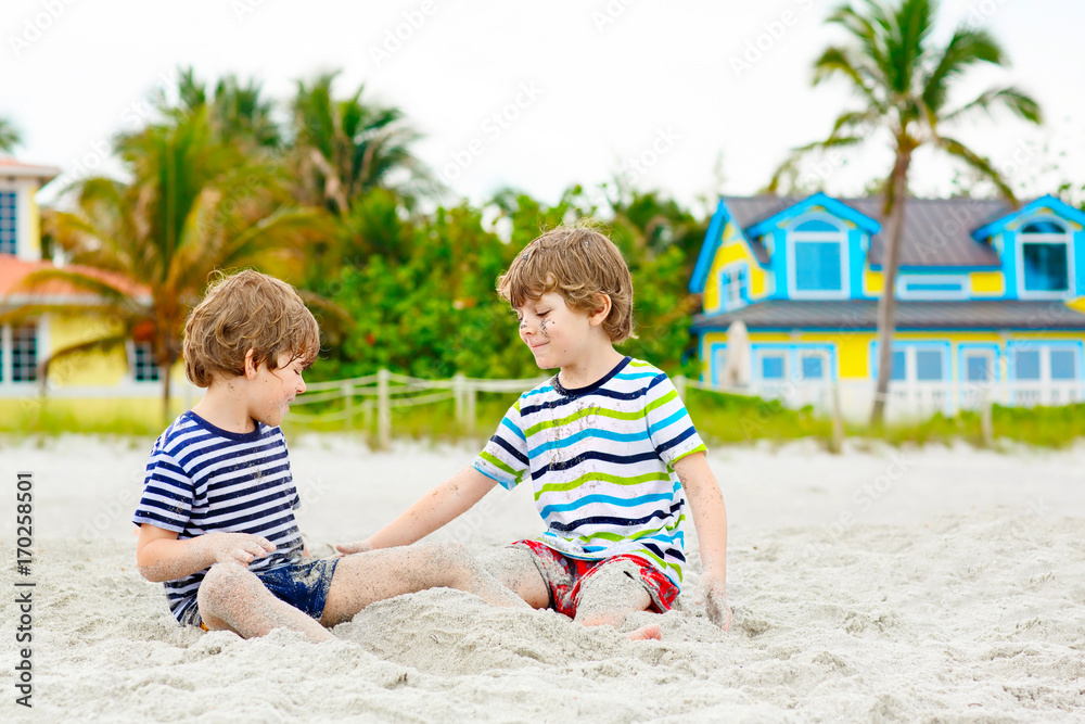 Two little kids boys having fun on tropical beach Two little kids boys having fun on tropical beach