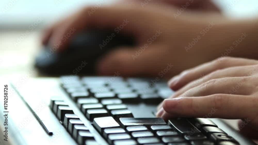 Male hands on close-up on an keyboard and a mouse working at office Male hands on close-up on an keyboard and a mouse working at office