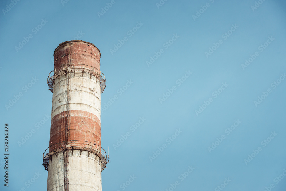 high red-white industrial factory pipes on the blue sky