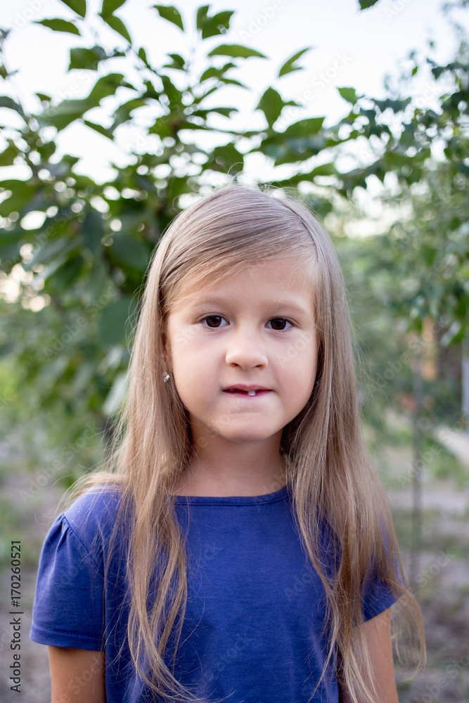 Young little girl without a front tooth in the countryside Young little girl without a front tooth in the countryside