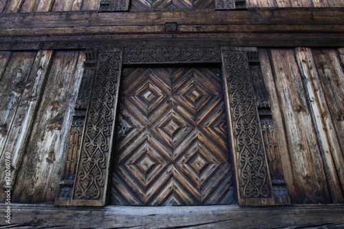 Wall Mural Carved door and doorjamb of an old 'Loft' storehouse of a traditional Norwegian