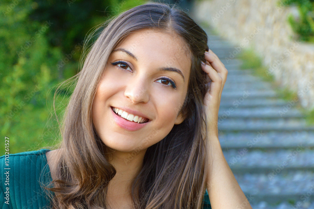 Face portrait of smiling woman with hand between hair. Teeth smiling girl. One model portrait. Face portrait of smiling woman with hand between hair. Teeth smiling girl. One model portrait.