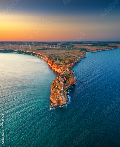 Aerial sunset view over cape Kaliakra with windmills farm, huge cliffs on black sea coast in Bulgaria photo