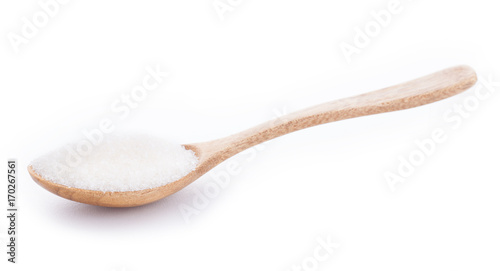 Sugar in wooden spoon on white background