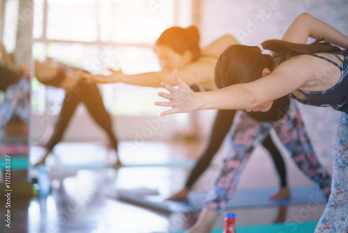 Group Young woman doing yoga and stretching exercises in the Studio.