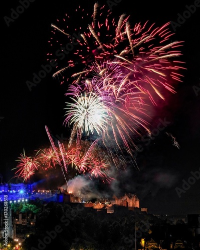 Fireworks over Edinburgh Castle with view of the city. Finale of Edinburgh International Festival in United Kingdom. photo