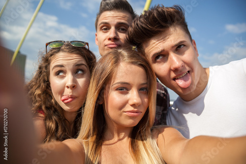 Selfie of group of teenage friends outdoor © leszekglasner