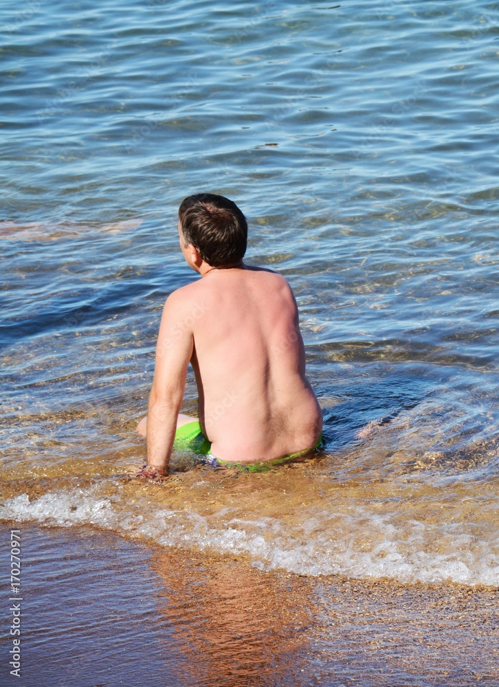 Man in meditation on the shore, unrecognizable person Man in meditation on the shore, unrecognizable person