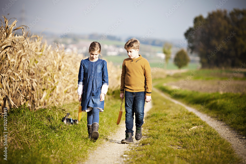 Girl and boy walking on path Girl and boy walking on path
