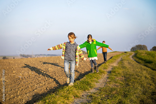 Three children playing outdoors