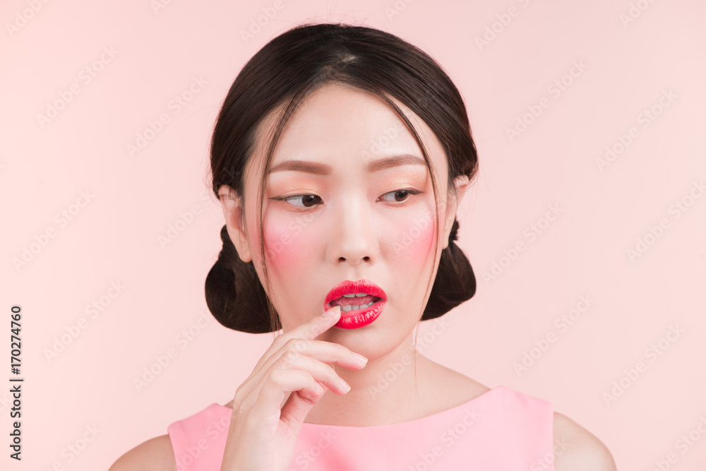 Beautiful asian girl with professional makeup and stylish hairstyle isolated on pink. Cosmetics and make-up Beautiful asian girl with professional makeup and stylish hairstyle isolated on pink. Cosmetics and make-up
