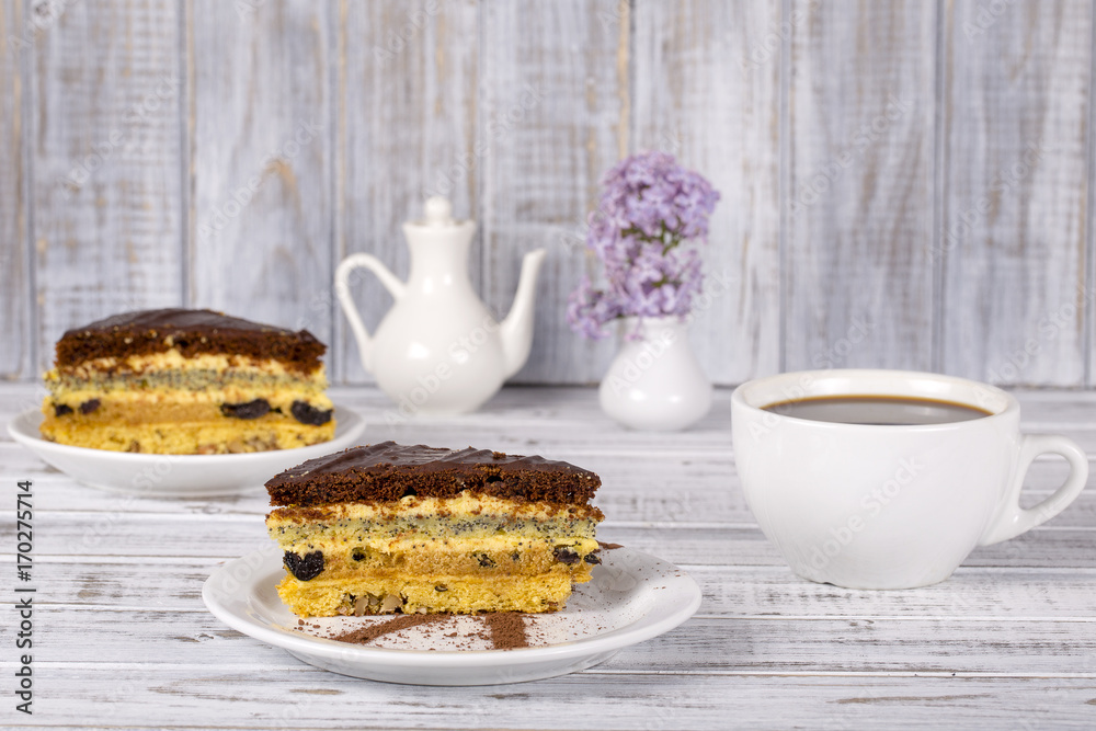 Chocolate cake from biscuit dough with poppy seed, prune, walnuts and cup coffee Chocolate cake from biscuit dough with poppy seed, prune, walnuts and cup coffee