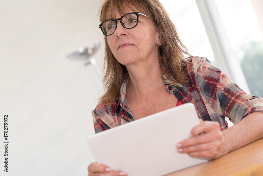Mature woman using a tablet Mature woman using a tablet