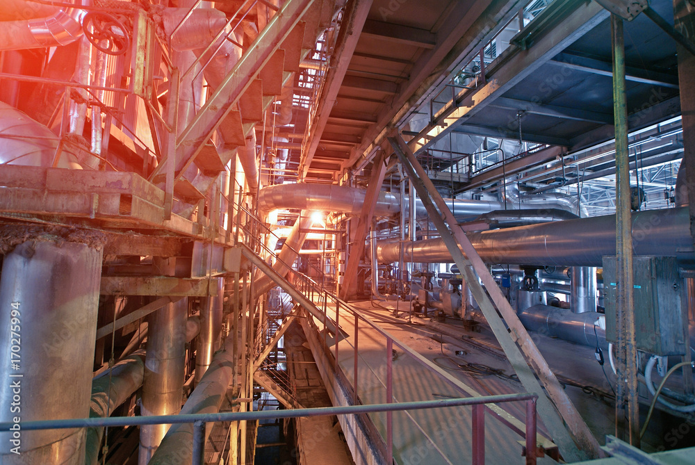 Equipment, cables and piping as found inside of a modern industrial power plant