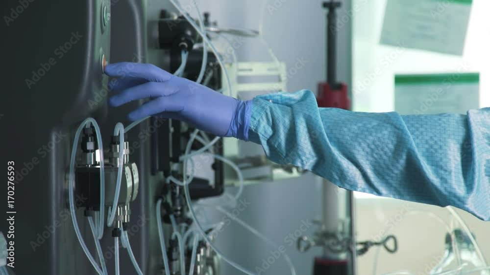 Hands of scientist in sterile blue protective gloves: laboratory assistant with chemical equipment. Work in scientific laboratory: control over the course of experiment and chemical reactions. Hands of scientist in sterile blue protective gloves: laboratory assistant with chemical equipment. Work in scientific laboratory: control over the course of experiment and chemical reactions.