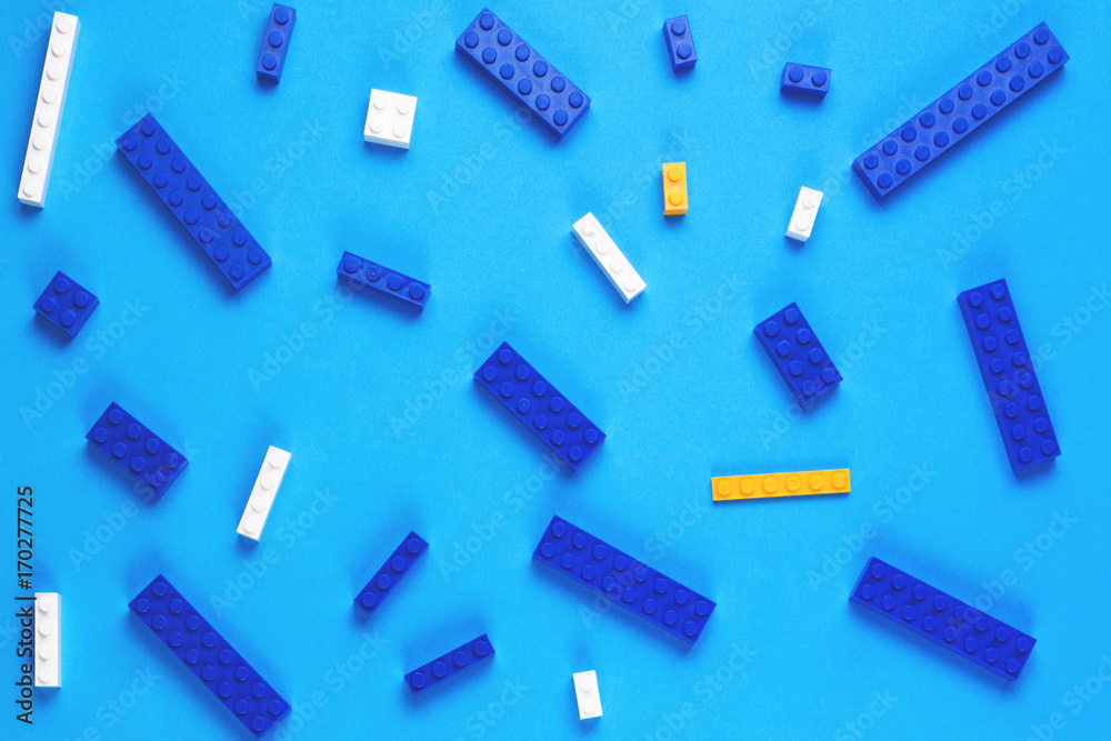 Toys construction bricks pattern on blue background Toys construction bricks pattern on blue background