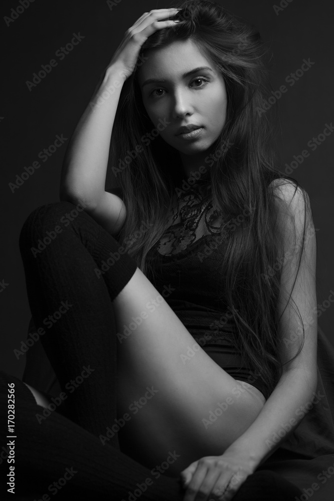 Beauty portrait of a young beautiful brunette girl with long straight flying hair. Magnificent hair. Black and white. Beauty portrait of a young beautiful brunette girl with long straight flying hair. Magnificent hair. Black and white.
