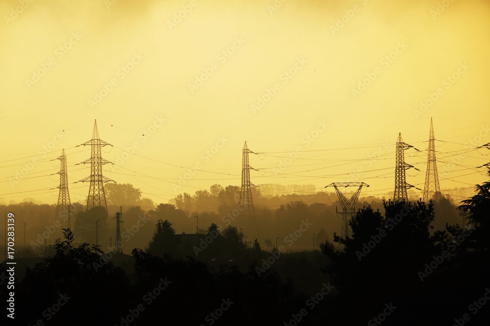Transmission lines and power towers in dawn, sepia, monochromatic photo