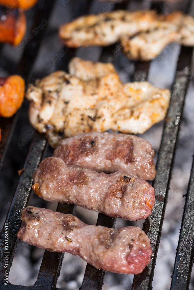 Selective focus on minced meat kebabs on the barbecue grill Selective focus on minced meat kebabs on the barbecue grill