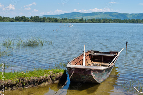 Fototapeta Naklejka Na Ścianę i Meble -  Moored boat by the shore and fresh,clean water