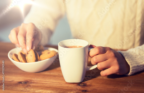close up of woman with cookies and hot chocolate