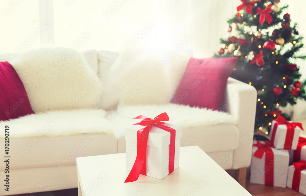 close up of christmas gift box on table at home close up of christmas gift box on table at home