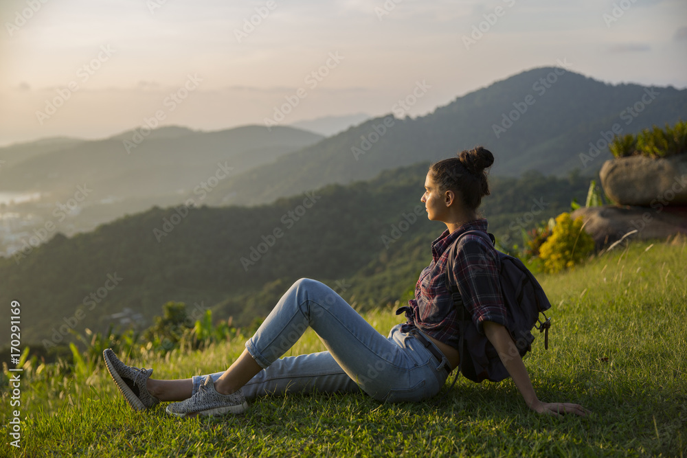 Hipster young girl with backpack enjoying sunset on peak mountain. Tourist traveler on background valley landscape view mockup. Hipster young girl with backpack enjoying sunset on peak mountain. Tourist traveler on background valley landscape view mockup.
