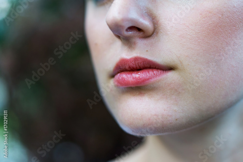 Close-up of a beautiful girl's face with light make-up. Concept fashion and beauty.