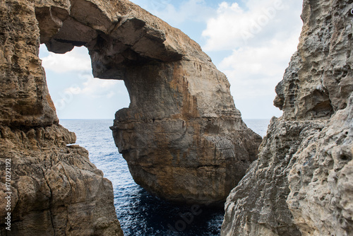 Wied il Mielah canyon, natural arch over the sea. Gozo, Malta © salajean