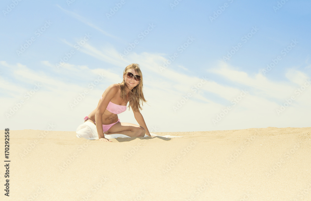 Tanned young female relaxing on the beach Tanned young female relaxing on the beach