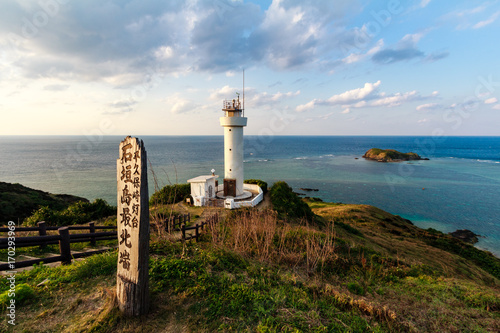 lighthouse Japan cape sunset next to the ocean photo