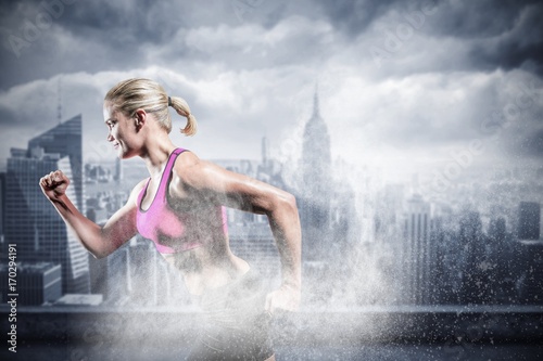 Composite image of muscular woman running in sportswear