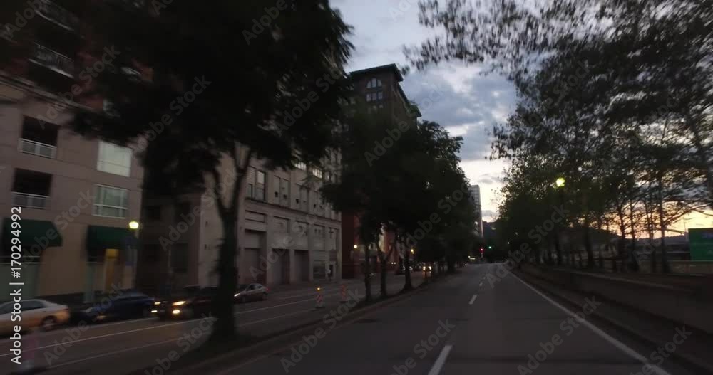 PITTSBURGH, PA - Circa September, 2017 - A three-quarter forward driving perspective past the businesses and storefronts in downtown Pittsburgh at dusk. PITTSBURGH, PA - Circa September, 2017 - A three-quarter forward driving perspective past the businesses and storefronts in downtown Pittsburgh at dusk.