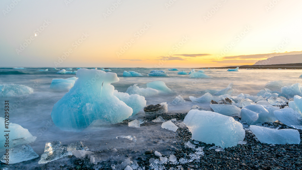 Icebergs in Jokulsarlon black beach at sunset, Iceland Icebergs in Jokulsarlon black beach at sunset, Iceland