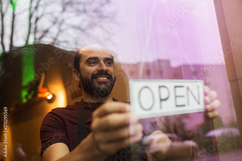 man with open banner at bar or restaurant window