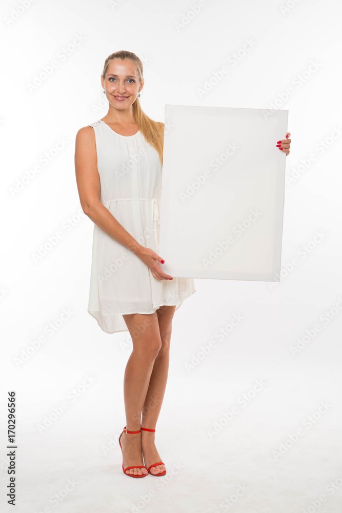 Young happy woman portrait of a confident businesswoman showing presentation, pointing placard gray background. Ideal for banners, registration forms, presentation, landings, presenting concept. Young happy woman portrait of a confident businesswoman showing presentation, pointing placard gray background. Ideal for banners, registration forms, presentation, landings, presenting concept.