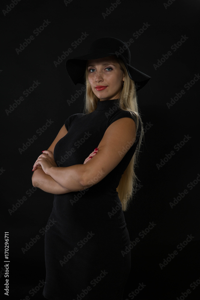 Young confident woman portrait of a confident businesswoman showing by hands on a black background. Ideal for banners, registration forms, presentation, landings, presenting concept Young confident woman portrait of a confident businesswoman showing by hands on a black background. Ideal for banners, registration forms, presentation, landings, presenting concept