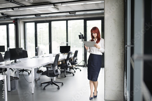 Businesswoman with tablet in her office working.