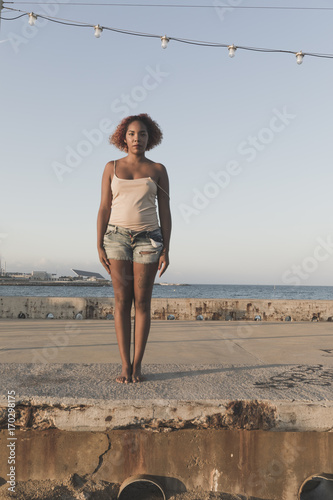 African American woman standup in shorts on Beach