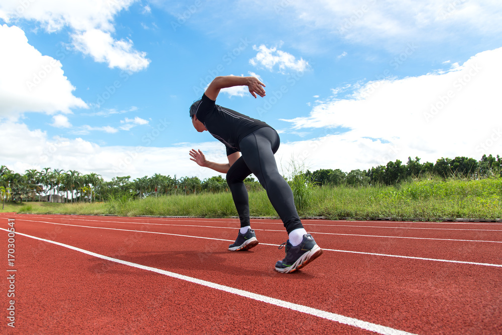Sport and fitness runner man running on racetrack training for the winner and target. Sport and fitness runner man running on racetrack training for the winner and target.